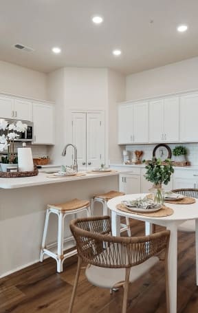 an open kitchen and dining area with a table and chairs