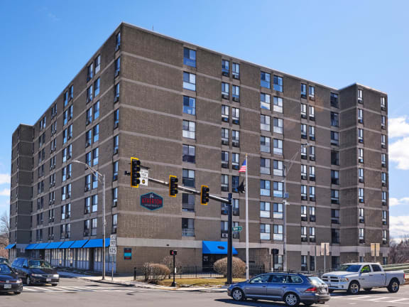 a brick apartment building on the corner of a city street