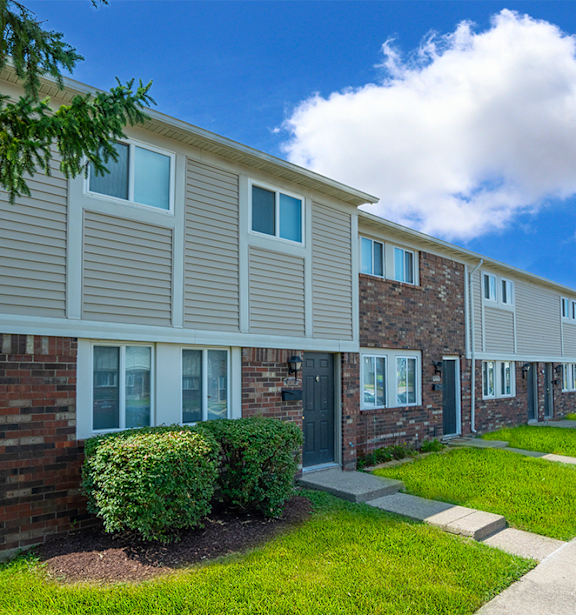 A row of houses with a clear blue sky above them.
