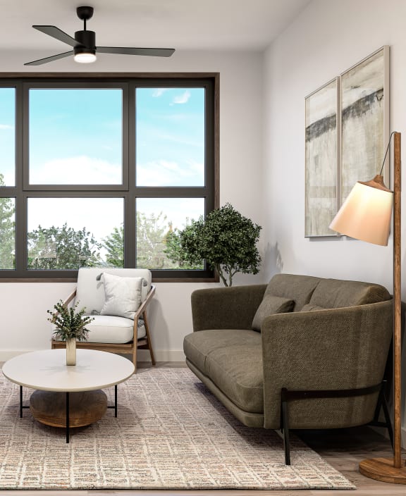 a living room with a large window and a couch and a coffee table