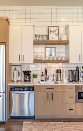 A kitchen with a refrigerator, cabinets, and a tiled backsplash at Timberridge Place Apartment Homes, Albany, 97322