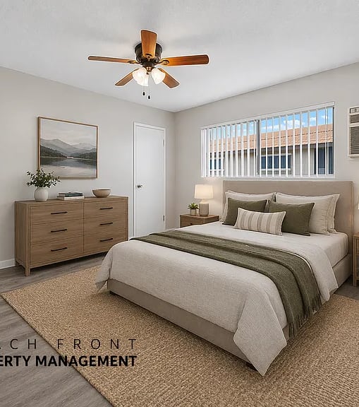A bedroom with a bed, dresser, and ceiling fan.