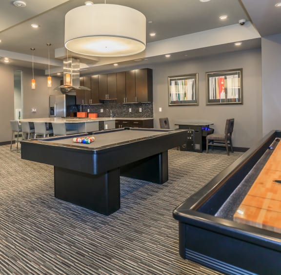 a game room with a pool table and a bar