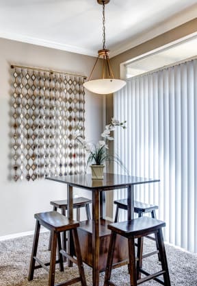 a dining area with a table and four stools at Links at High Resort, Rio Rancho, NM, 87124