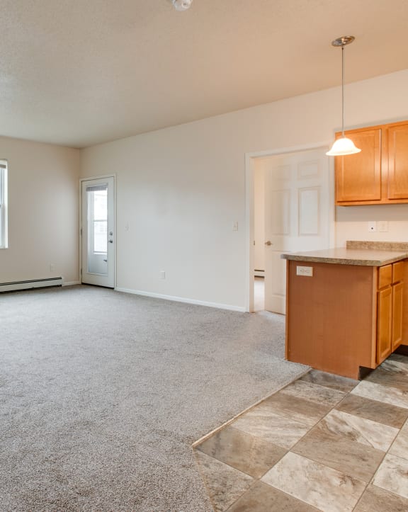 the living room and kitchen of an empty house