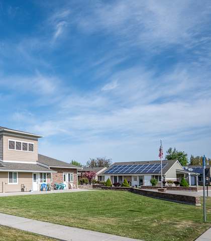a house with solar panels on the roof and a sidewalk