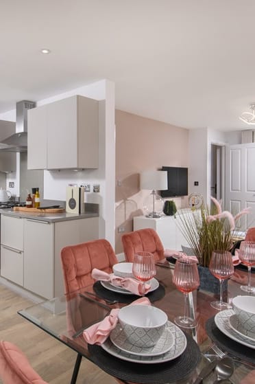 a living room and kitchen with a table and chairs