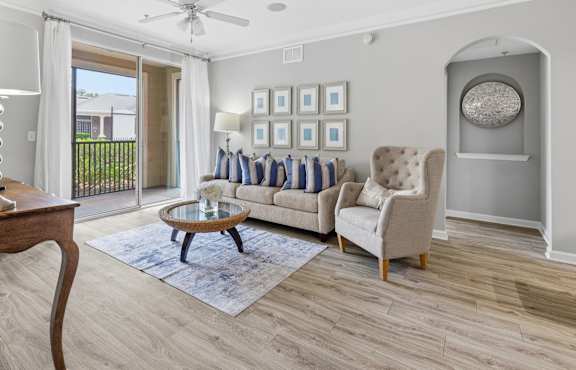 A living room with a sofa, armchair, and a coffee table.