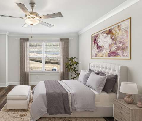 a bedroom with a bed and a ceiling fan