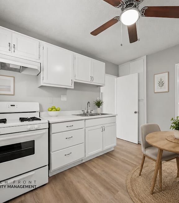 A well-lit, modern kitchen and living room with a dining area.