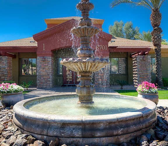A house numbered 701 has a fountain in front of it.