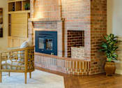 Thumbnail 2 of 2 - a living room with a fireplace and a large window