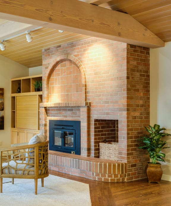 a living room with a fireplace and a large window