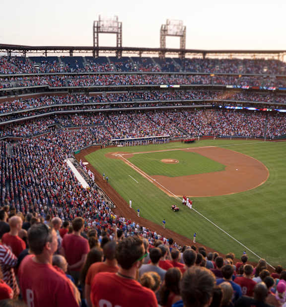 A baseball stadium is filled with fans watching a game.