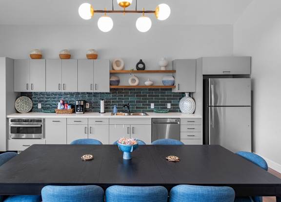 a living room with a kitchen and a dining room at Wind River Lodge, Lenexa