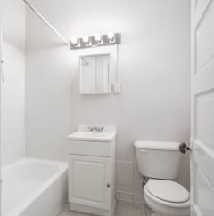 a bathroom with a toilet and a sink and a bath tub