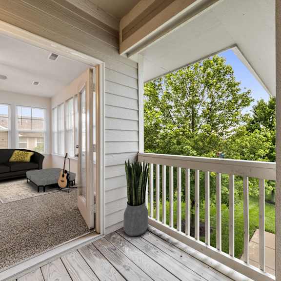 A balcony with a couch and a guitar on it.
