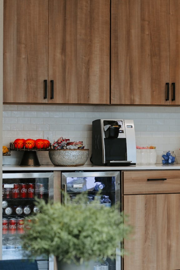 a kitchen with wooden cabinets and a black microwave