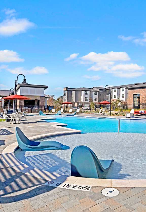 our apartments offer a swimming pool with lounge chairs and umbrellas