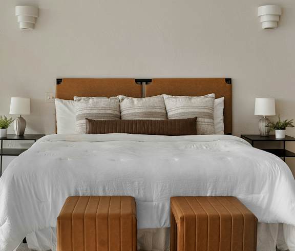 A bedroom with a large bed and a view of the city.
