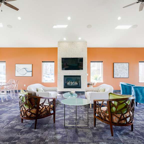  clubhouse room filled with furniture and a fire place in the back