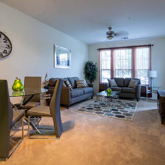 A living room with a large clock on the wall.
