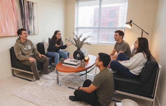 A group of people sitting in a circle in a room.