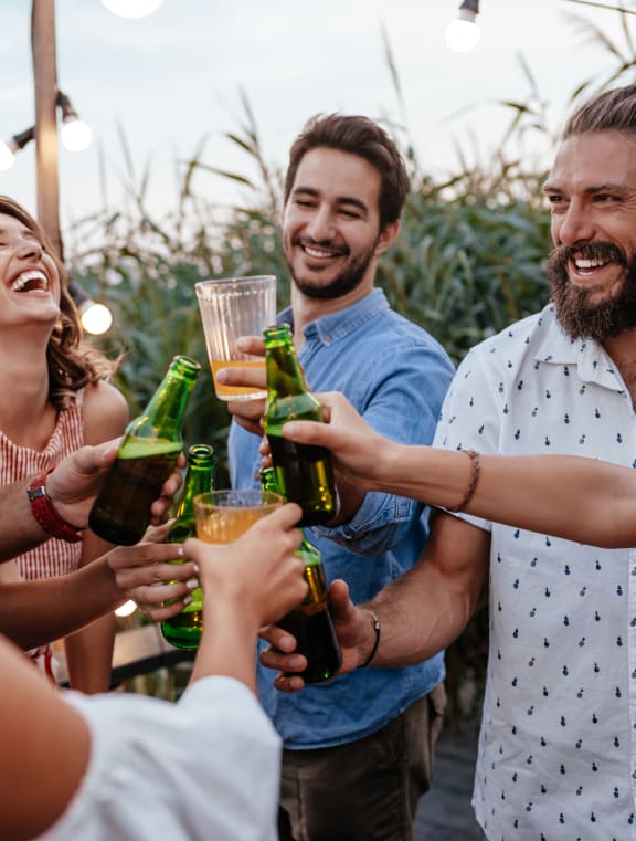 a group of people celebrating with drinks at a party