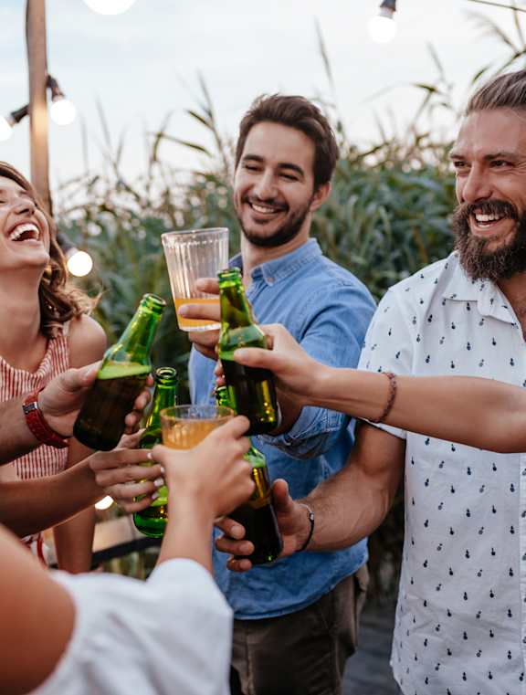 a group of people celebrating with drinks at a party