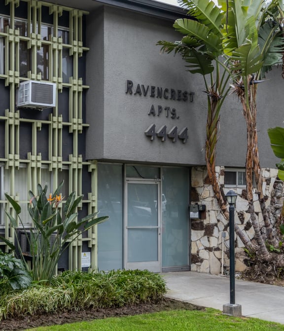 a building with a lawn and trees in front of it