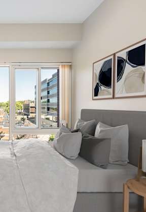 a couch with blue pillows in a living room at Residences at Manchester Place, Manchester, 03101
