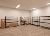 Thumbnail 25 of 28 - A room with a white wall and a wooden floor with a shelf and a box on it.