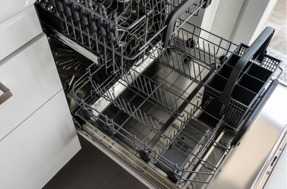 a dishwasher in a kitchen next to a cabinet