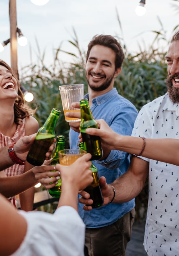 a group of people celebrating with drinks at a party