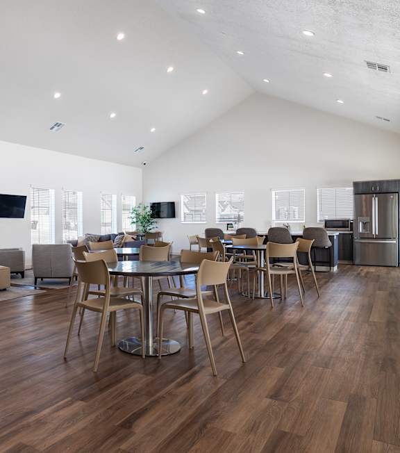 A modern living room with a wooden floor and furniture.