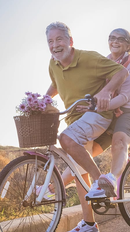 Lifestyle photo of older couple riding a bike together at Mission Pointe Apartments, Jacksonville, FL, 32218