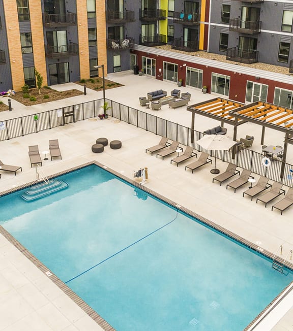 an overhead view of a swimming pool and an apartment building