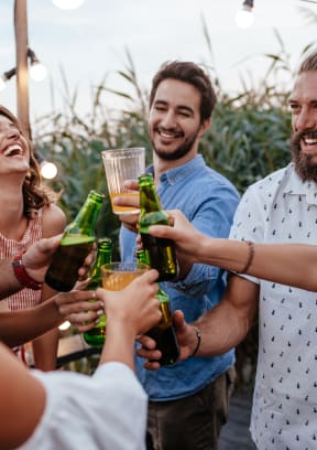 a group of people celebrating with drinks at a party