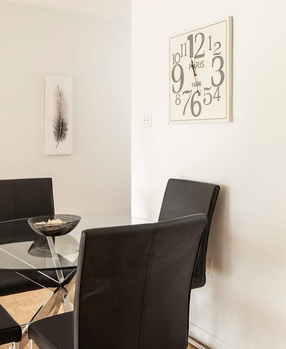 A living room with a white couch and a dining table.