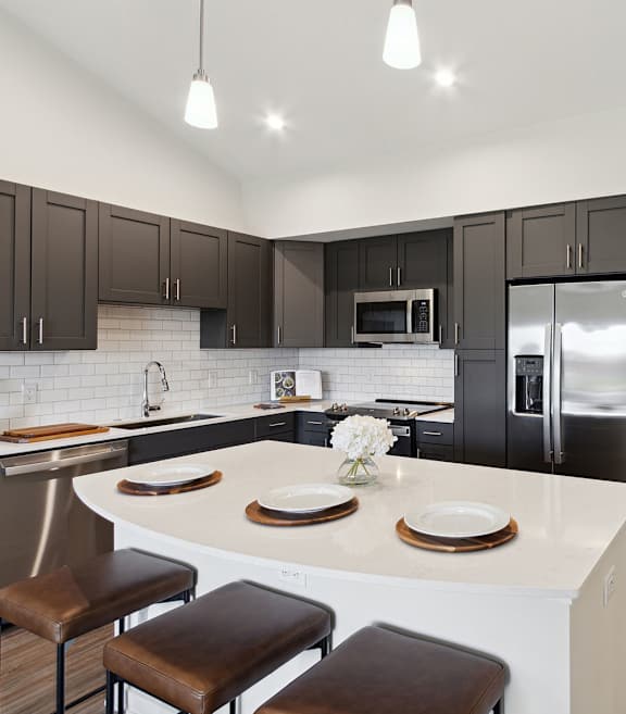 A modern kitchen with dark brown cabinets and stainless steel appliances.