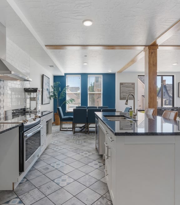 a kitchen with an island and a dining room with a table and chairs at City View St. George Apartments, Utah, 84770