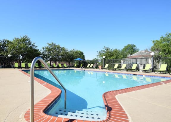 a large swimming pool with chairs around it at Chinoe Creek Apartments in Lexington KY