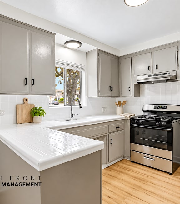A well-lit, modern kitchen and living room with a dining area.