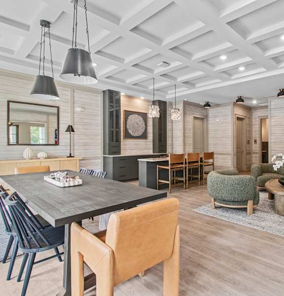 A modern dining room with a wooden table and chairs.