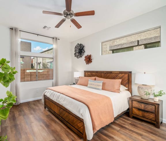 a bedroom with a large bed and a ceiling fan