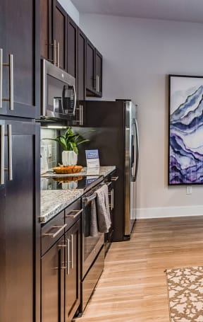 an open kitchen with stainless steel appliances and granite counter tops