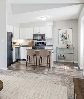 A modern kitchen with a dining table and chairs.