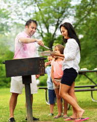 Family Having BBQ Together Smiling