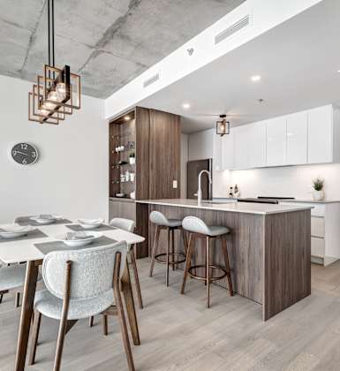 A modern kitchen with a dining table and chairs.