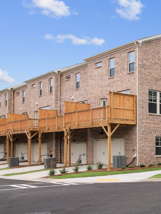 a large brick building with a wooden balcony